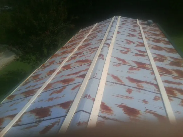 Rusted metal roof panels with new wood purlins before replacement — Storm Damage Roof Repair in Wheeling by Roofing Brothers