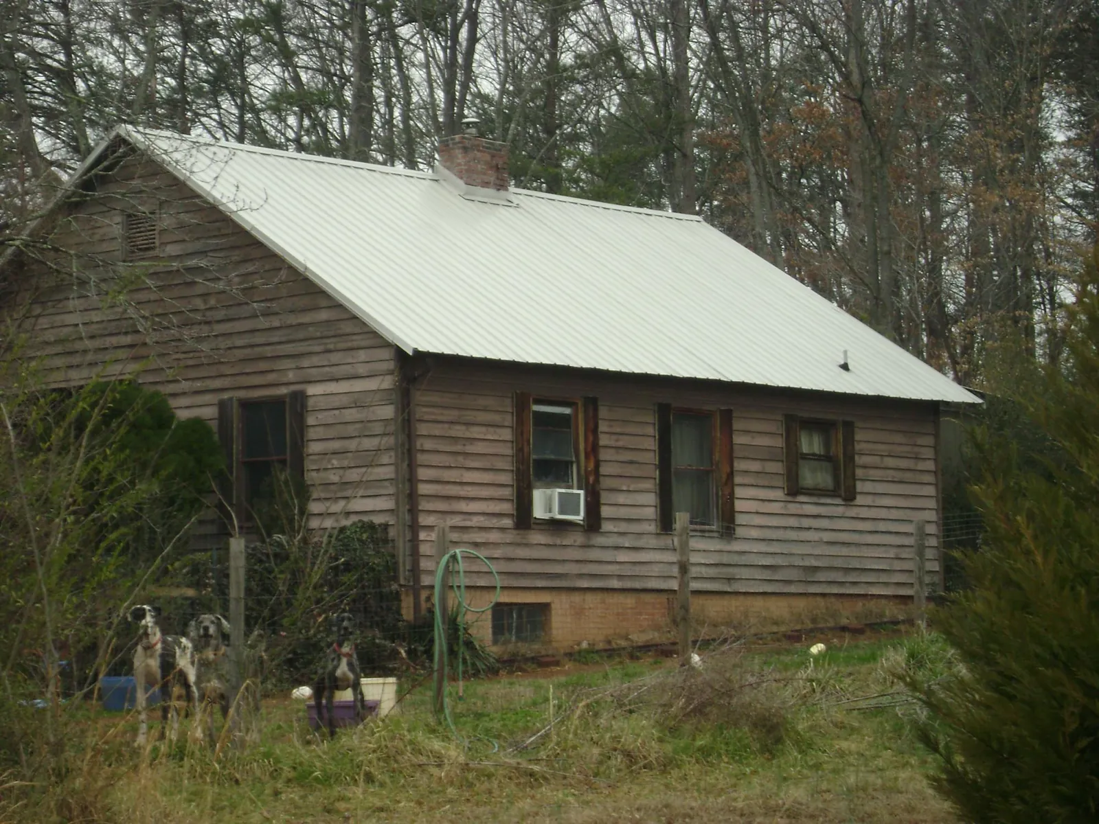 White metal roof on an old wood sided farmhouse, from a Metal Roof Installation job in Wheeling